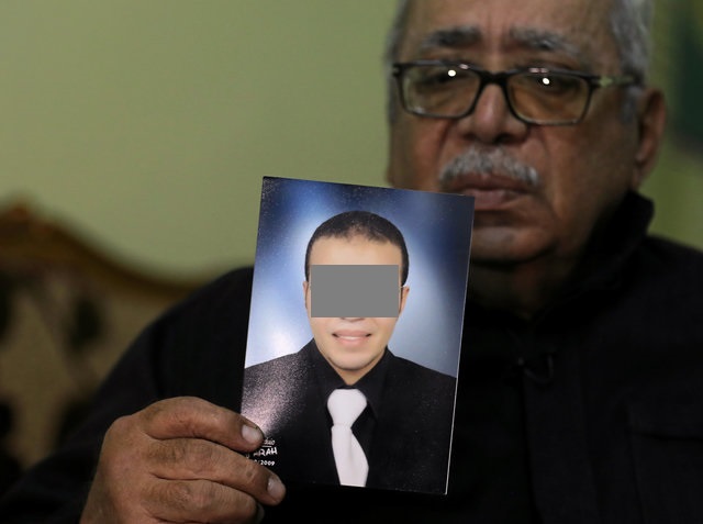 Reda Abdullah al-Hamamy, the father of Abdullah Reda al-Hamamy who is suspected of attacking a soldier in Paris' Louvre museum, holds a picture of his son during an interview with Reuters in Daqahliya, Egypt, February 4, 2017. REUTERS/Mohamed Abd El Ghany     FOR EDITORIAL USE ONLY. NO RESALES. NO ARCHIVES