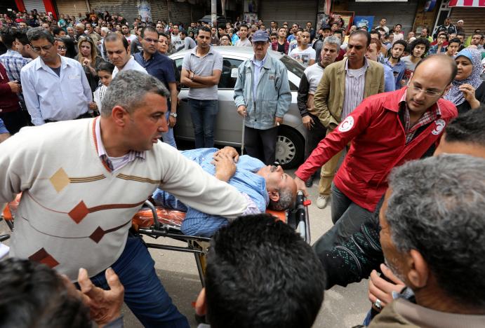 A victim is seen on a stretcher after a bomb went off at a Coptic church in Tanta, Egypt, April 9, 2017. REUTERS/Mohamed Abd El Ghany